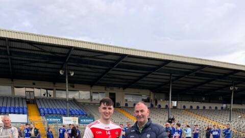 Kerry GAA Hurling Officer, Liam Ross, presenting the Man-of-the-Match trophy to Kilgarvan's Daniel Casey.