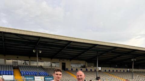 The Kilgarvan captain, Richard O' Sullivan, receiving the cup from Liam Ross, Kerry GAA Hurling Officer. 